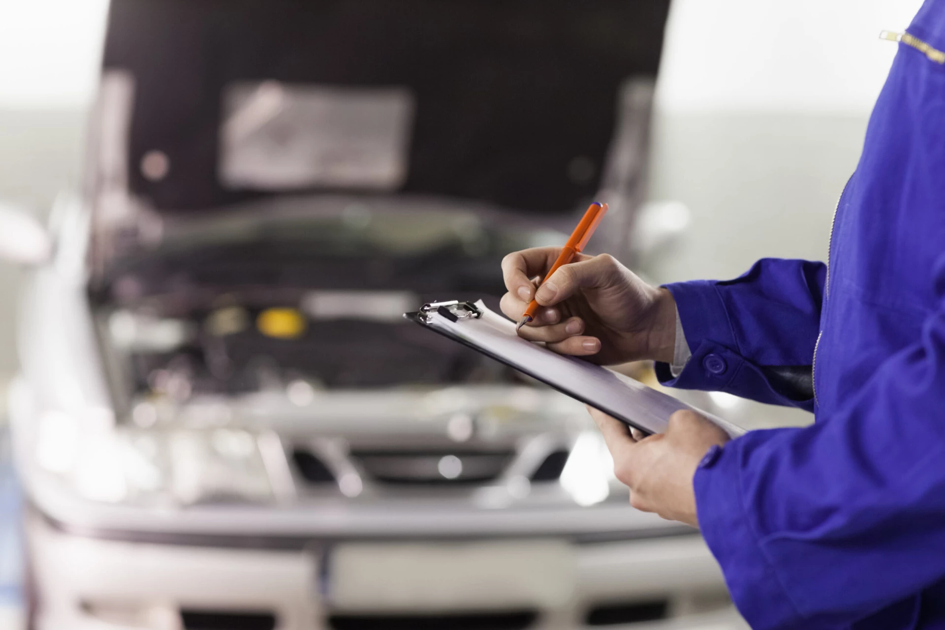car-maintenance-man-inspecting-car-engine