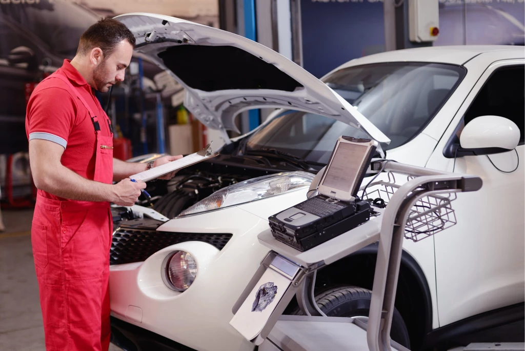 A mechanic inspecting a car during a car service