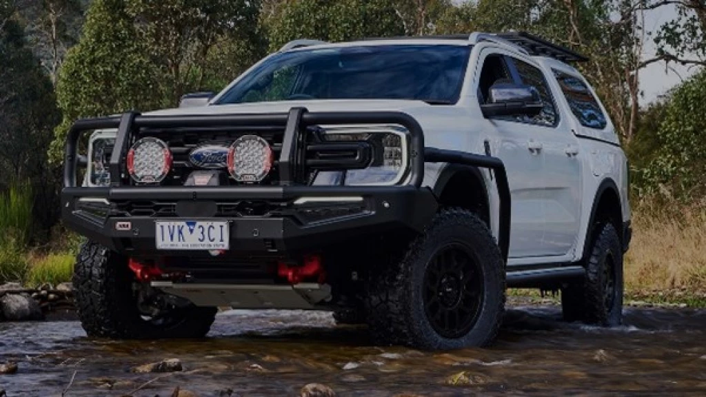 An image of a Ford Ranger driving through wet and rough terrain