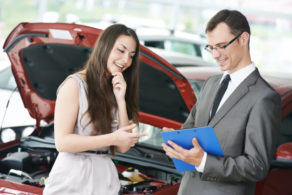 Customer discussing with car dealer at dealership