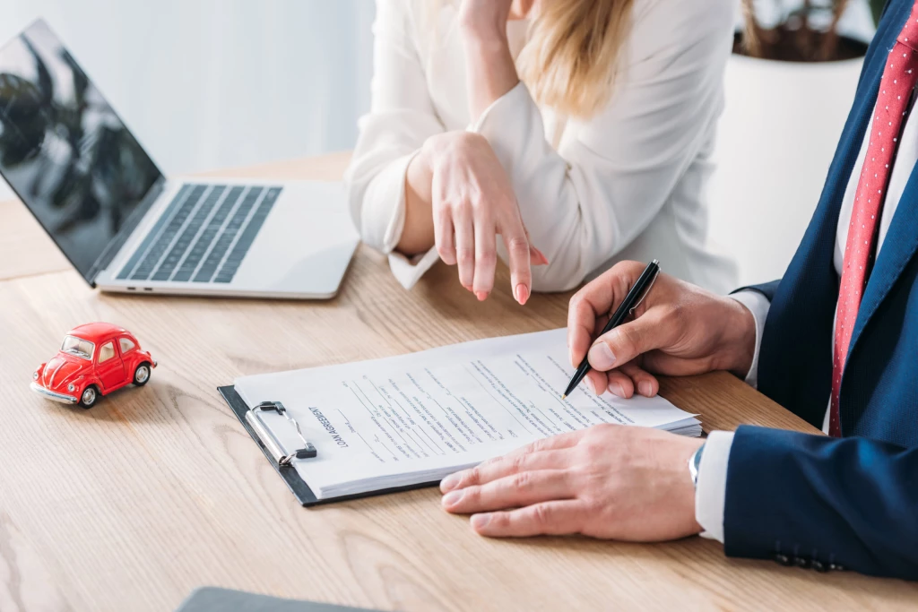 A car dealer discusses a lease with a customer